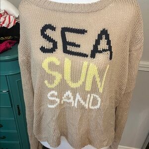Wooden Ships Tan Sweater with Black, Yellow, and White Text